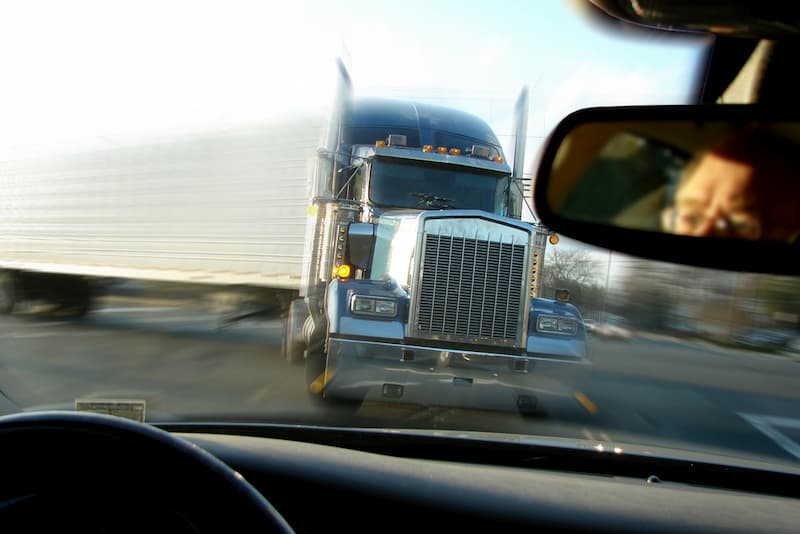 Truck in drivers rear view mirror