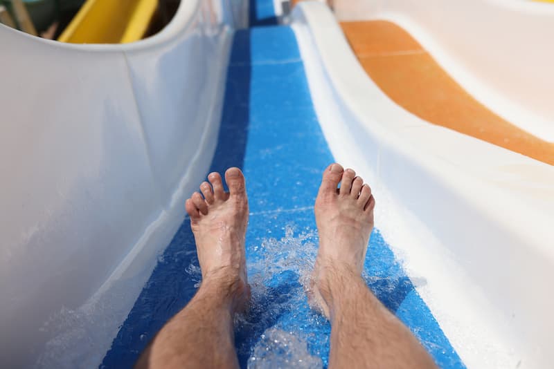 Male feet on background roller coaster