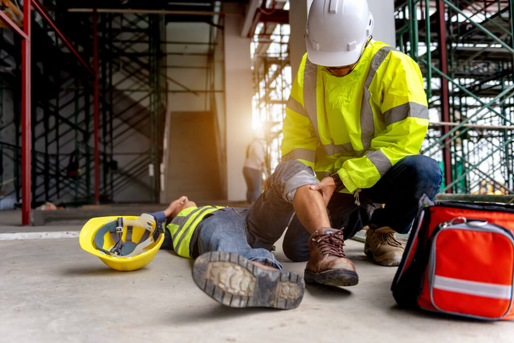 First aid support accident at work of construction worker at site. Builder accident falls scaffolding on floor.