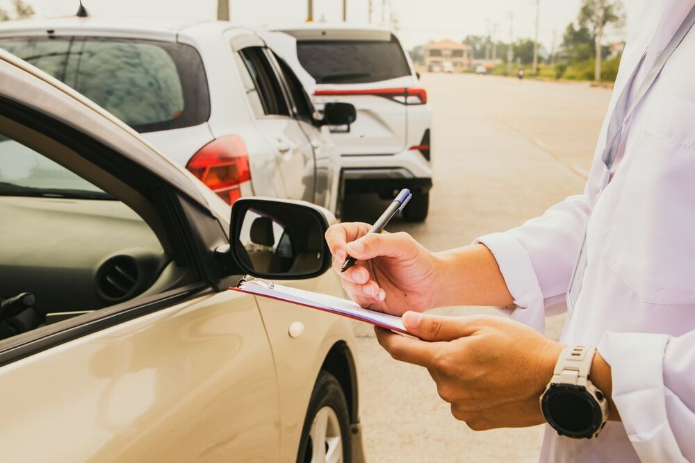 insurance and police writing down information about an accident