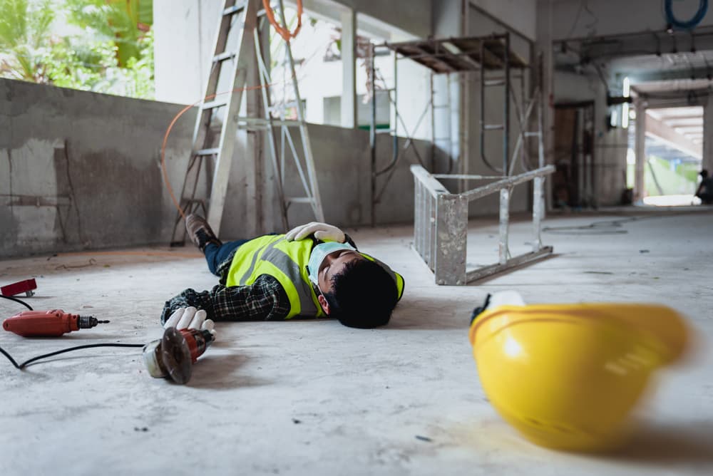 construction worker who has fallen off a ladder with no one around