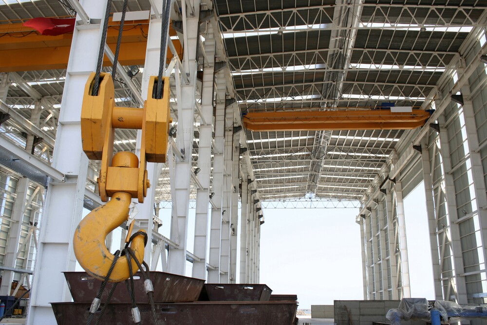 large crane on a job site attached to equipment