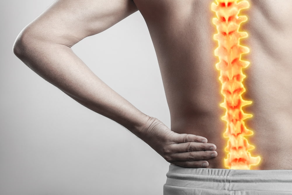 Man with inflamed spinal cord injury pain highlighted in glowing red