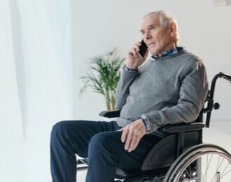 disabled person in wheelchair making a phone call