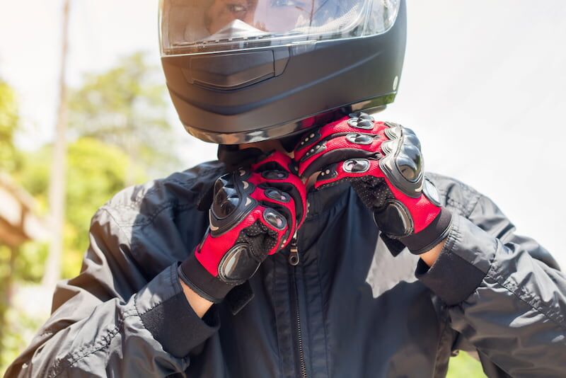motorcycle driver putting on gloves