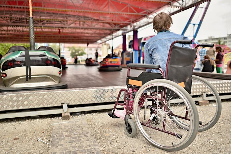 Woman in wheelchair watching on carousel
