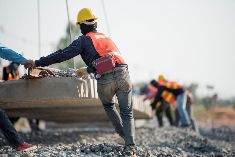 Worker holding concrete blocks