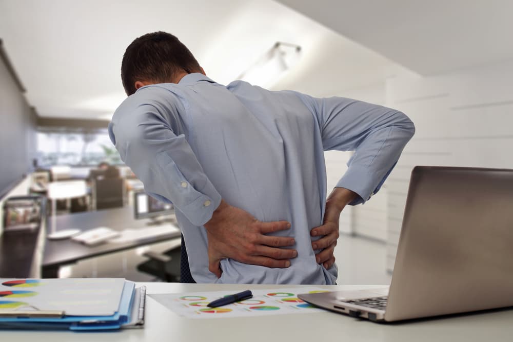 Worker with back pain in the office