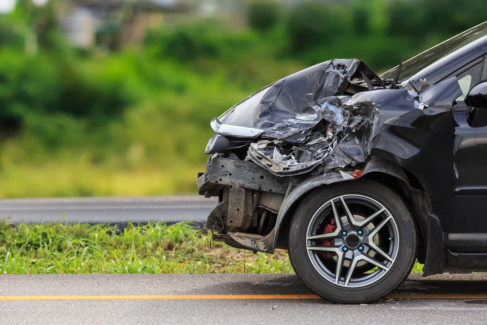 car on the side of highway with totaled front from head-on collision in North Myrtle Beach