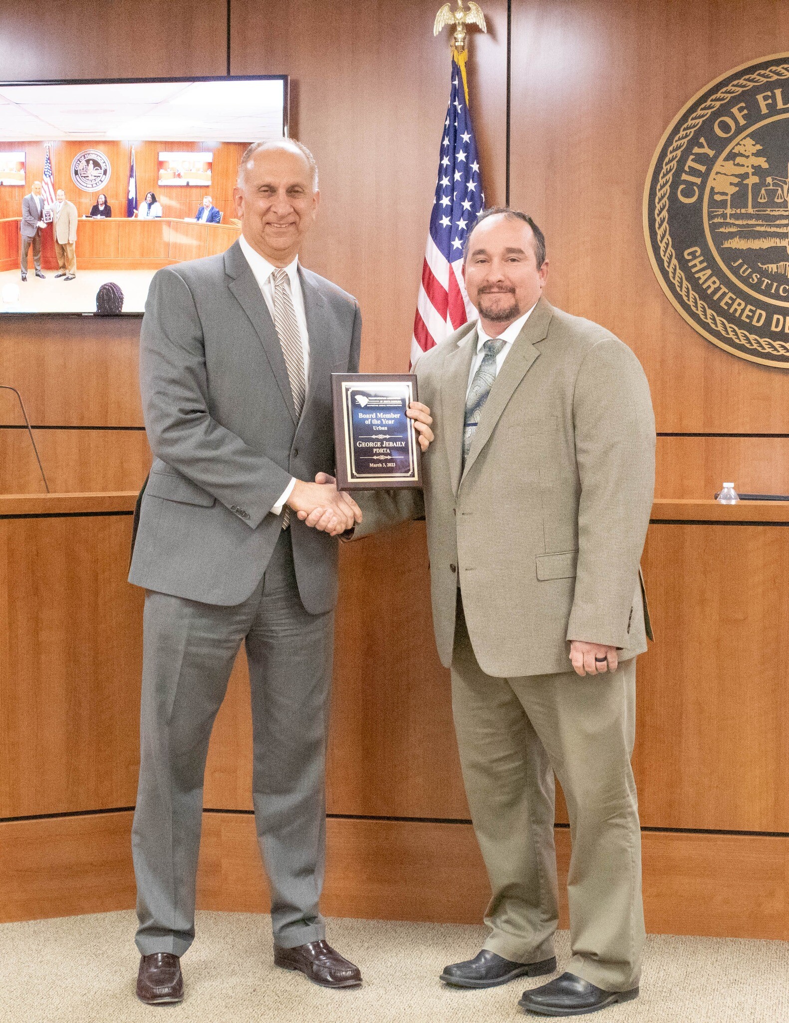 George Jebaily receiving award plaque from Don Strickland